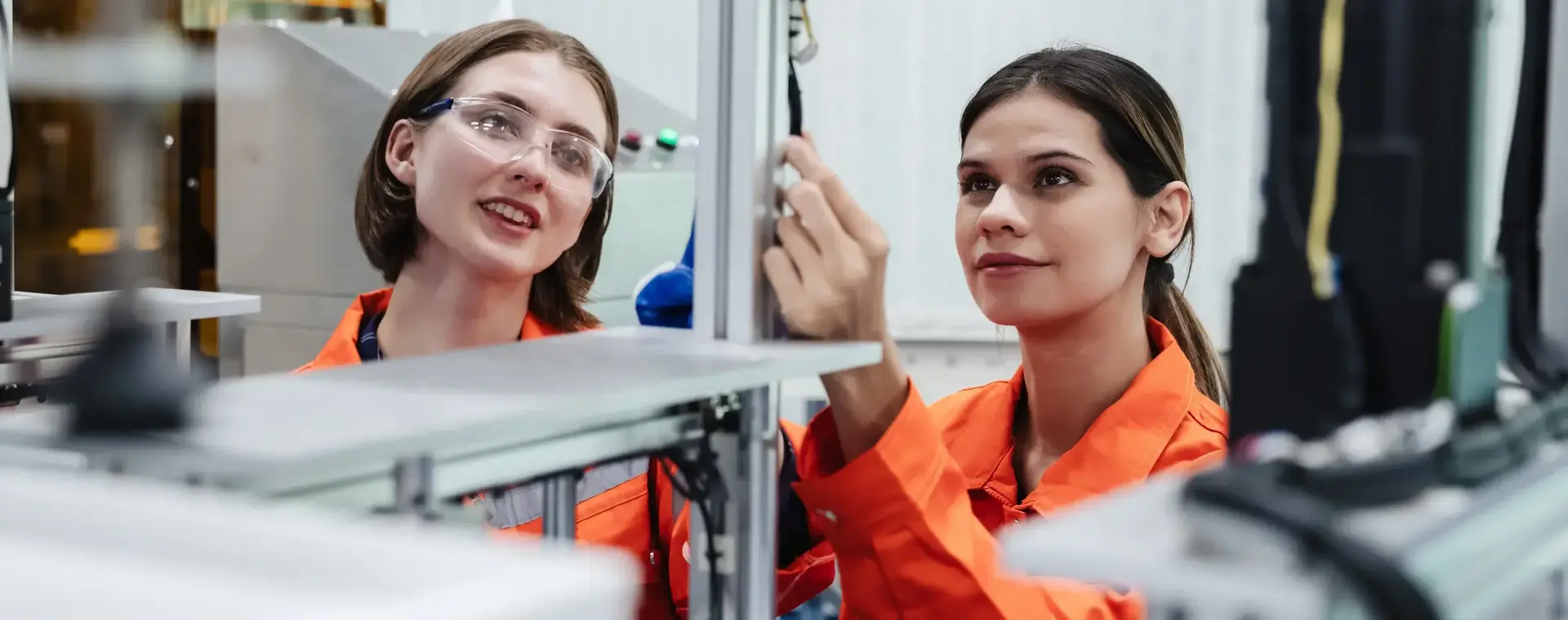 studenten mechatronica in oranje overalls bestuderen machine
